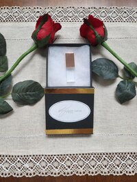Thumb drive in gift box surrounded by red roses