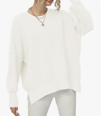 woman modeling a white sweater
