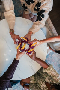 kat smiling with black jacket on shoulders