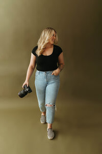 Wedding Photographer Jessica Cameron seated with her professional camera
