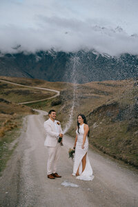 Bride and groom  popping champagne at their Queenstown elopement