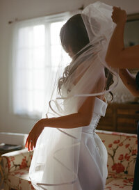 bride in tulle veil getting ready on wedding day