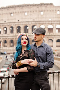 Photo of newly engaged couple embracing in front of the Colosseum. Taken by Rome Photographer, Tricia Anne Photography.
