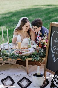 LGBTQ brides enjoy a boho picnic after their Denver elopement.