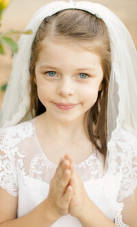 girl in white first communion dress