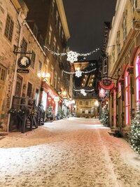 snowfall and christmas lights in old quebec city