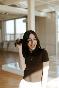 vintage videographer holding her camera at Tapestry Hall wedding