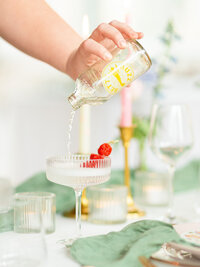 Pouring drink in a coupe glass