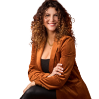 woman in orange blazer and curly hair