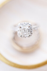 close up of white diamond ring with blurred background