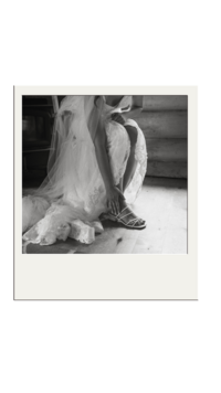 Bride puts her shoes on during the getting ready portion of the day