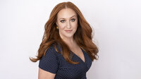 Headshot of a red hair actress.