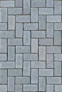 Grey concrete patio pavers are arranged in a geometric pattern on a walkway in Missoula Montana.