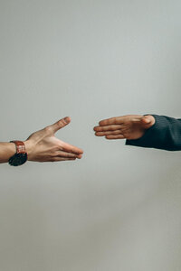 Vendor and groom give a handshake