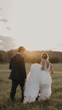 bride-and-groom-walking-during-sunset