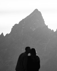A couple silhouetted in front of the Grand Teton.