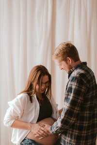 couple pose for maternity session in peoria il