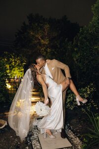 couple shares a kiss after wedding in south florida