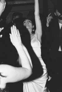 bride dancing with arms in the air