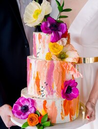 Watercolor orange and pink cake with bright flowers