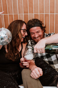 Couple partying in a bathtub with champagne and a disco ball in Breckenridge, Colorado.