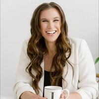 Brook jefferson smiling headshot with brown hair and hand on chin