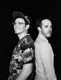 Two musicians stand together confidently against a neutral background – clean, expressive branding photo by Mewphotovideo