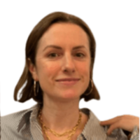 Ellen Cumber Director with shoulder-length brown hair in a dark speckled top, smiling in a portrait photo.