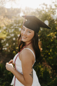 Headshot of Kylie Hagerman photography, with graduation hat and beautiful sunlight pouring through