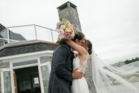 Newlyweds kiss as their exit ceremony at Bull Point Estate wedding