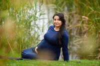 Pregnant woman sitting on the ground for her maternity photography session in Burlington, Ontario 