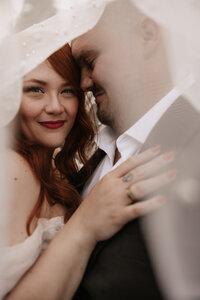 A Canada wedding couple under her veil