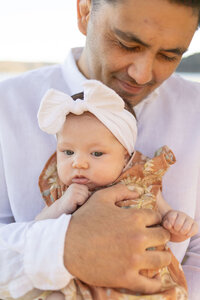 Newborn baby with big white headband