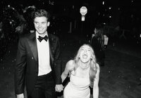 Engaged couple kisses on city streets