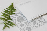 Artisan Kind branded stationary next to a fern