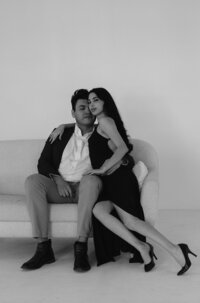 Couple sitting on couch in photo studio in albuquerque.
