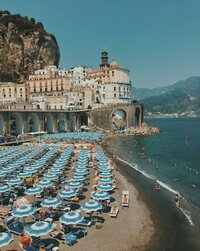 Portofino Beach with rows of blue and white beach umbrella