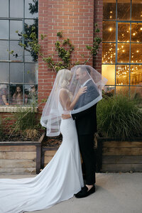 Wedding photos in front of Moss, Denver wedding venue