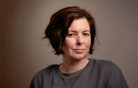 headshot of Kate Cashin holding her camera