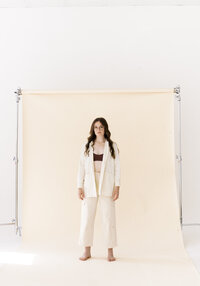 woman stands in front of backdrop