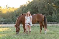 woman holding horse lead line  smiling