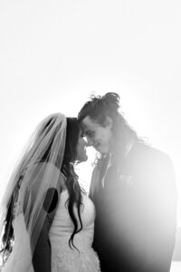 A tattooed queer couple laughing during their alternative wedding in Springfield, MO, captured by Chelsea Stanford.