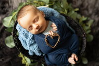 Newborn baby boy sleeping in wicker basket wrapped in navy blue blanket, Lehigh Valley newborn session