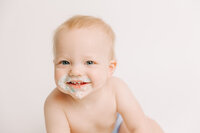 Cake smash session of one year boy during his one year session in the studio.