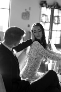 Groom touching bride's face in church by one of the top east coast wedding photographers