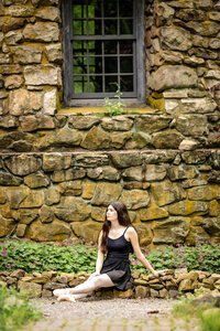 Beautiful dancer sitting in front of the water tower at Cross Estate Gardens in New Jersey 