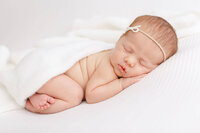 newborn baby sleeping peacefully while lying on belly.