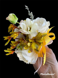 Bright yellow and white corsage with a black background