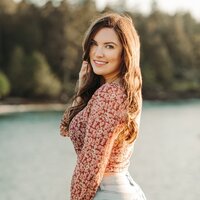 Utah Wedding Photographers capture woman wearing long sleeve shirt and smiling 