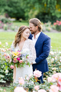 Bride and groom posing with florals in Ohio before their Ohio wedding captured by Ohio wedding photographers, The Cannons Photography